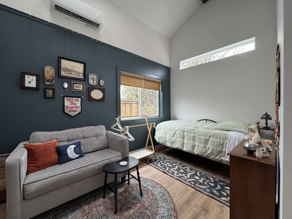 Bedroom and sofa area inside the 262 sqft tiny house ADU in Kent, WA showing the multipurpose living layout