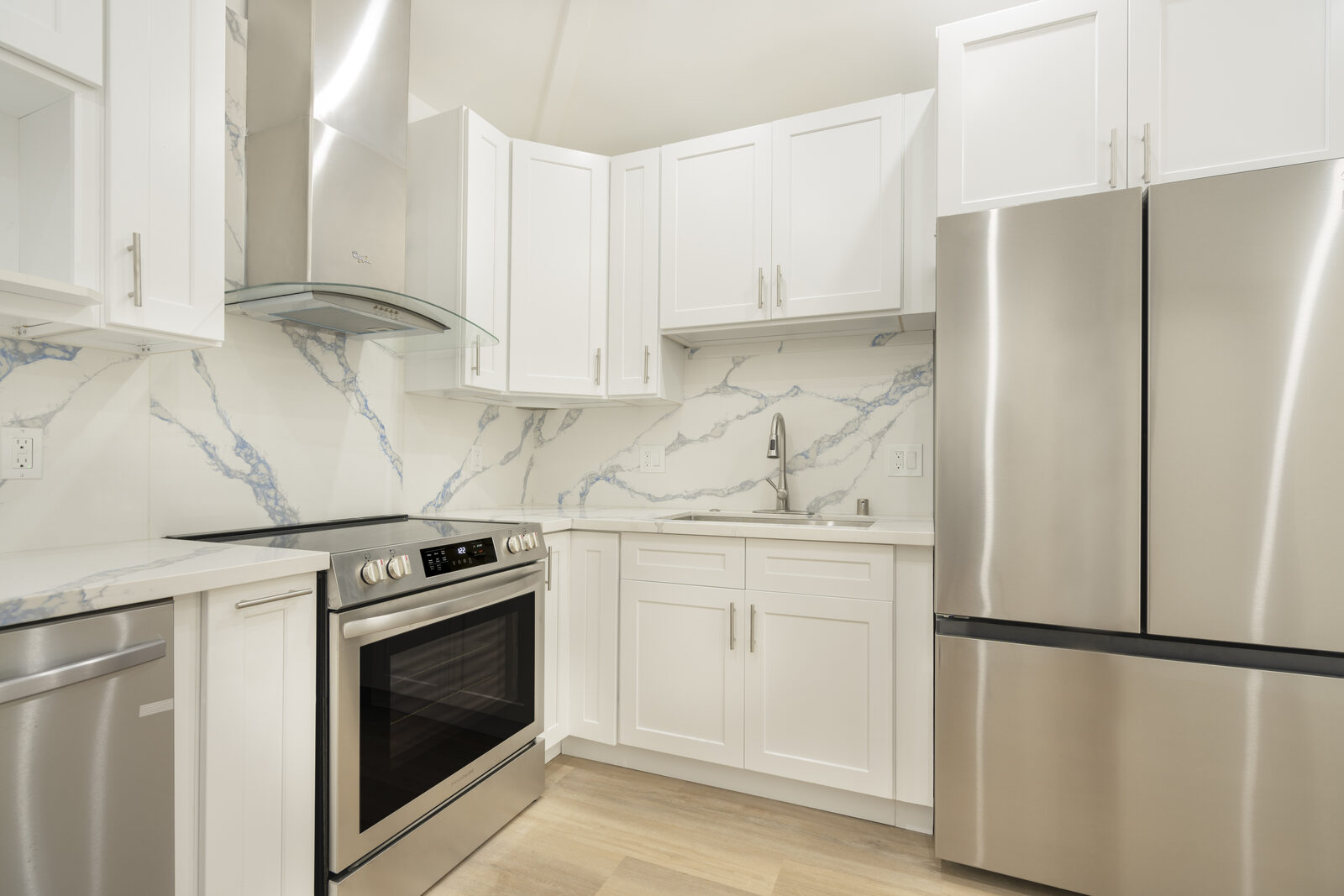 Stainless steel range, sink, and refrigerator in the completed Thousand Oaks garage conversion kitchen