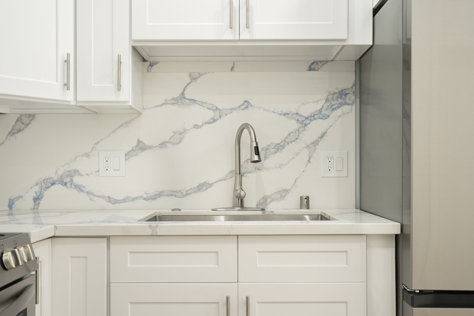 Kitchen sink and blue-veined full-height backsplash in the Thousand Oaks garage conversion ADU