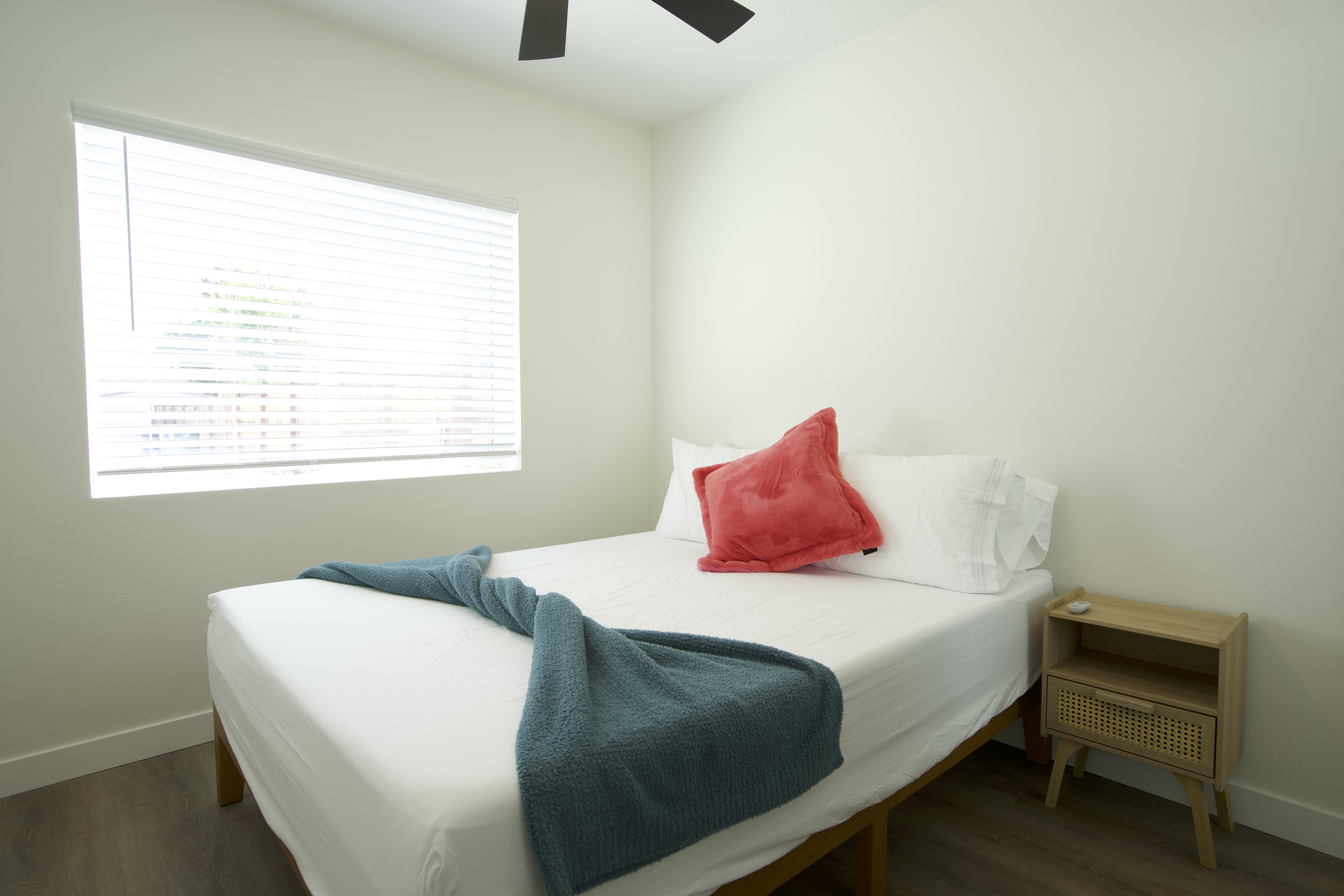 Cozy ADU bedroom with natural light, ceiling fan, and modern furnishings