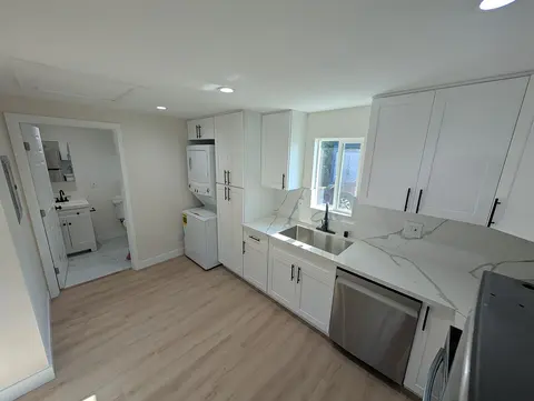 ADU kitchen and laundry with stacked washer and dryer