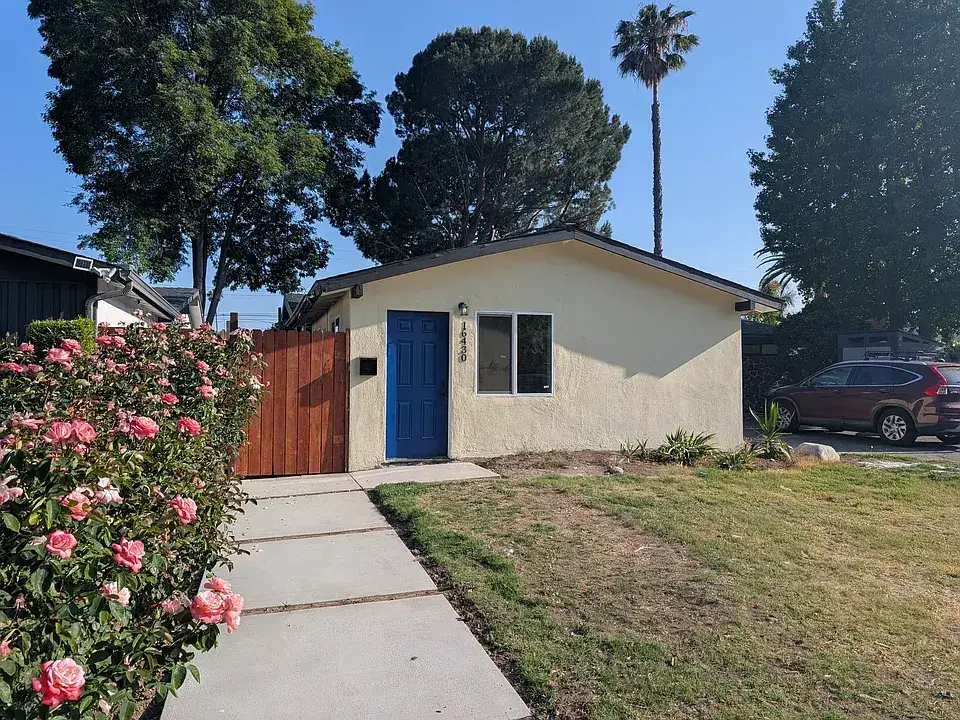 Exterior of the Granada Hills garage conversion ADU with a blue front door